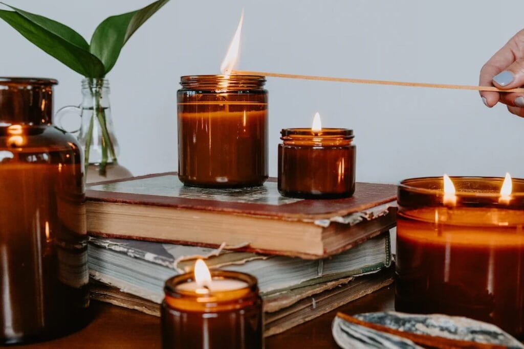 Close up shot of a hand lighting candles with a long match