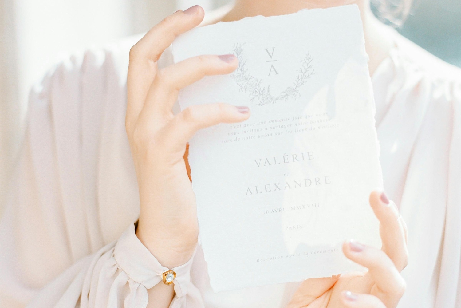 woman holding a wedding invitation