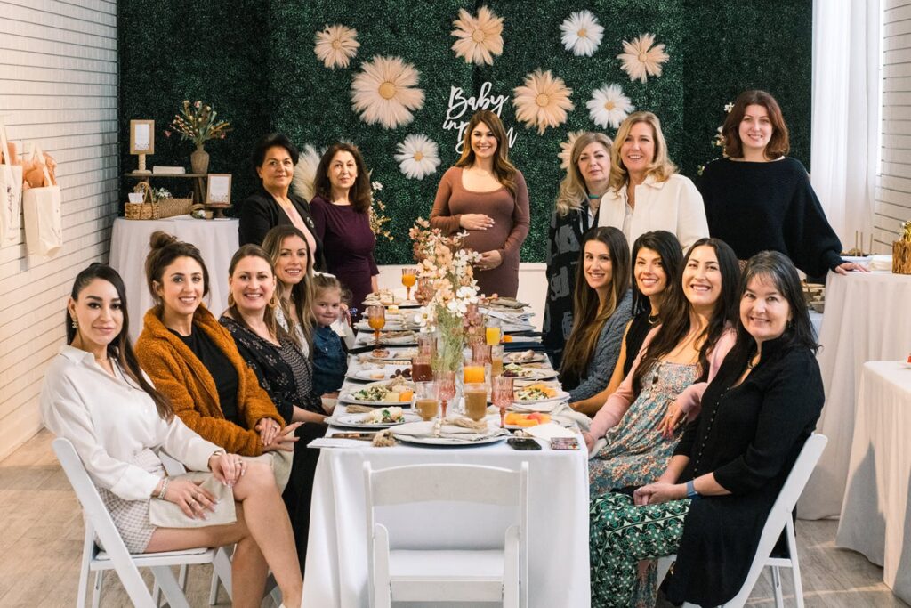 women gathered around a table at a baby shower