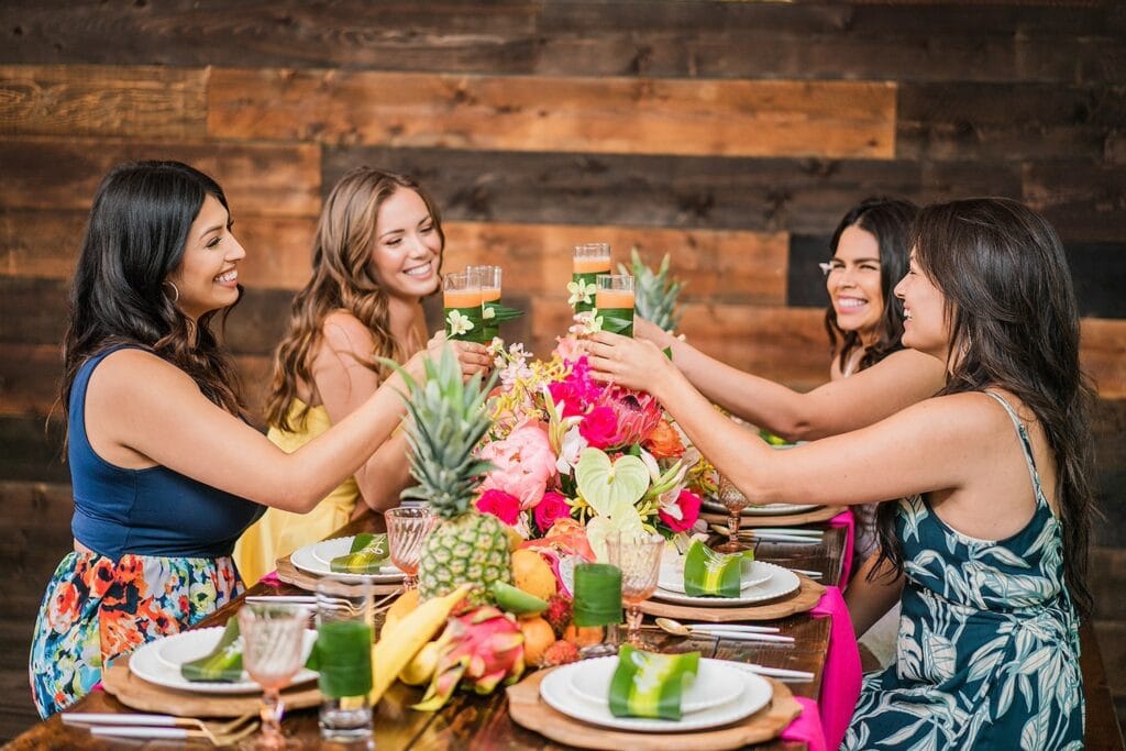 Woman toast at a tropically-themed table