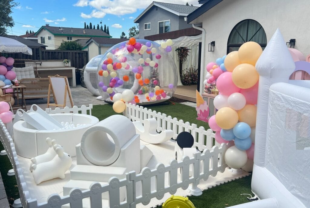 garden filled with giant kids toys and balloons