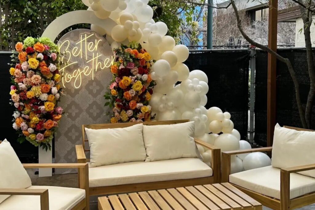 better together light design behind a set of beige outdoor sofas