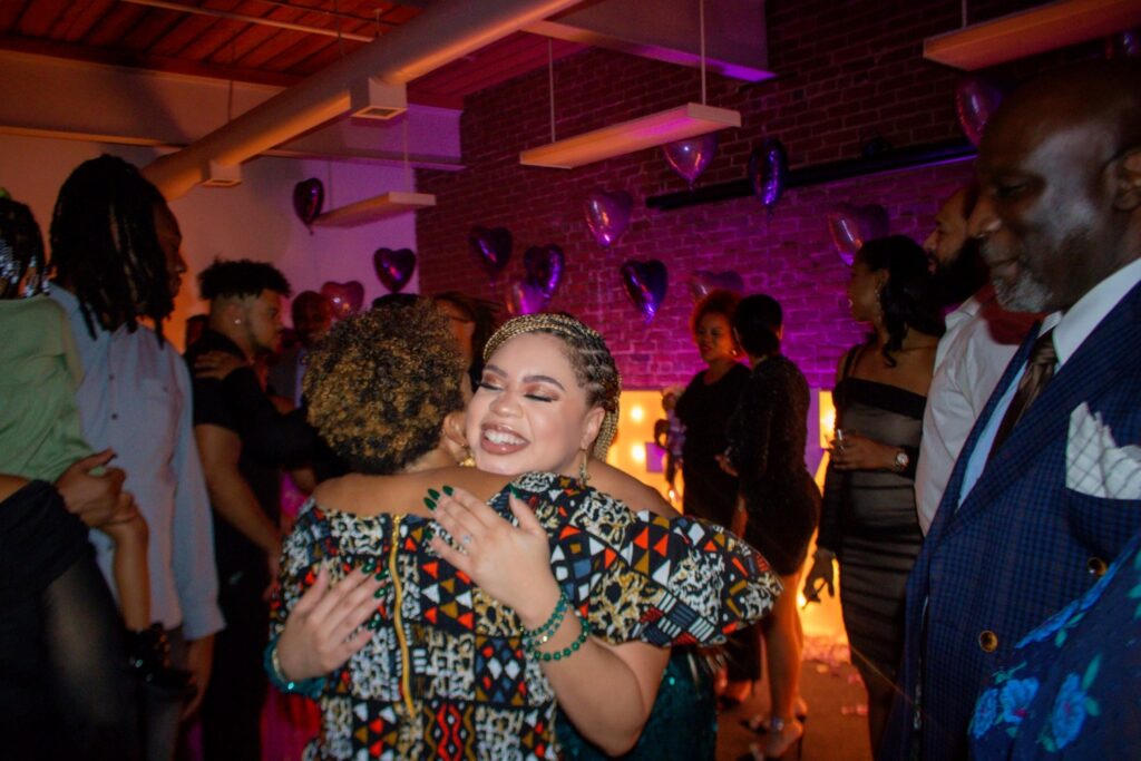 two people hugging at a party
