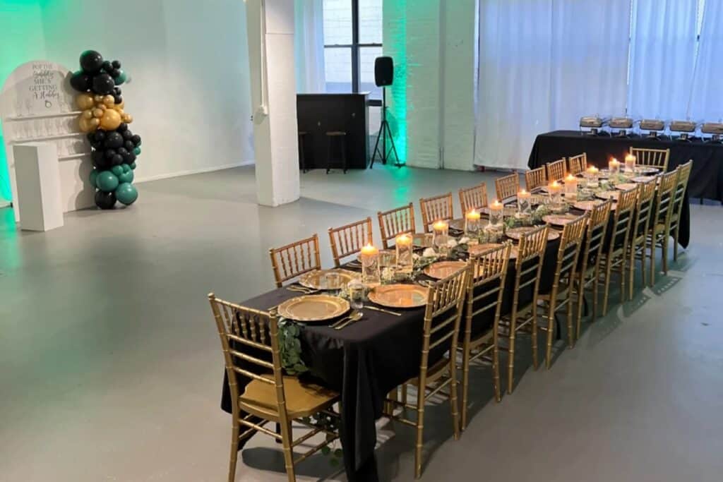 banquet hall with gold, green and black tablescape