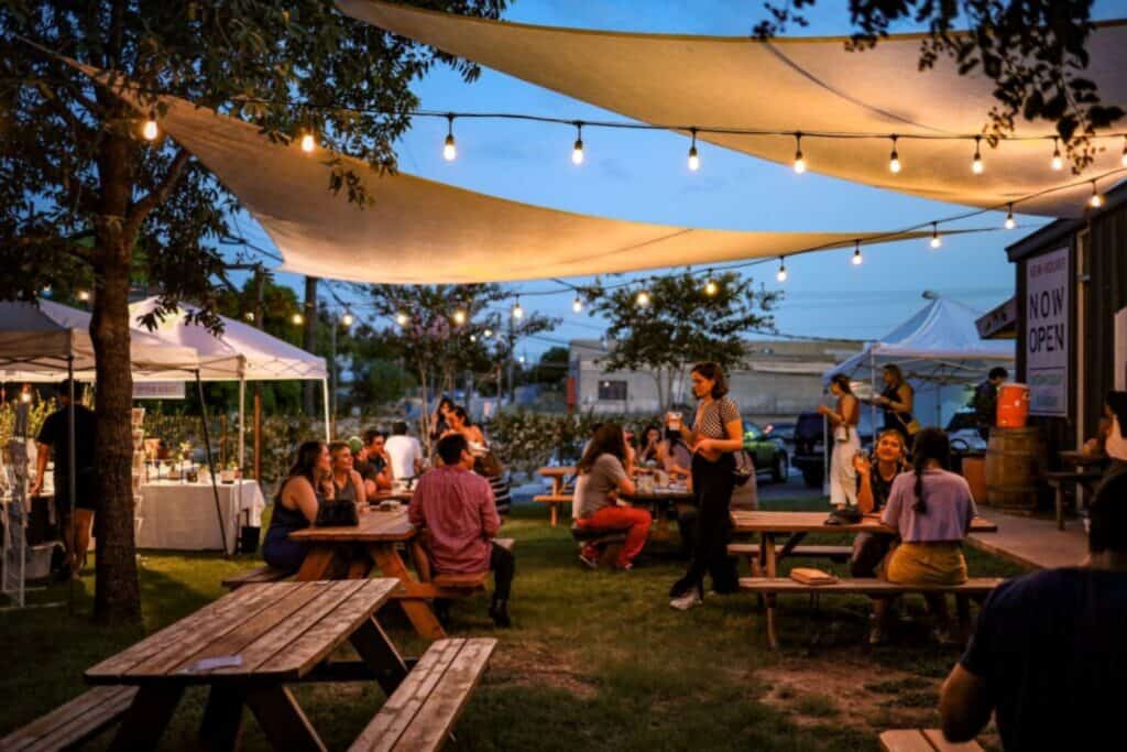 outdoor garden party with guest drinking cider