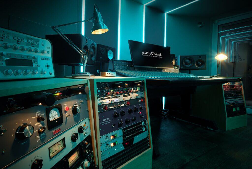 Professional music studio with audio equipment and glowing monitors.