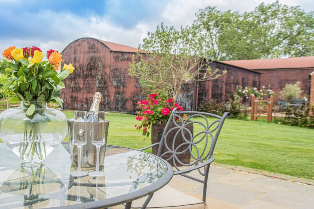 a table with champagne and flowers at a Stunning Historic Farm
