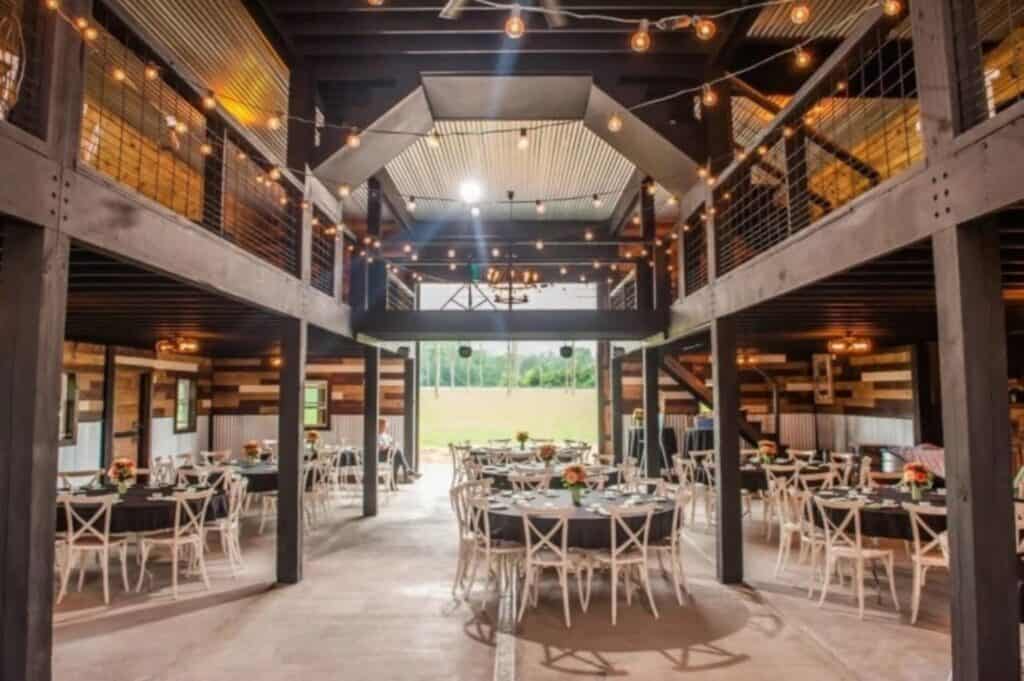 barn with many table and chairs set for dinner