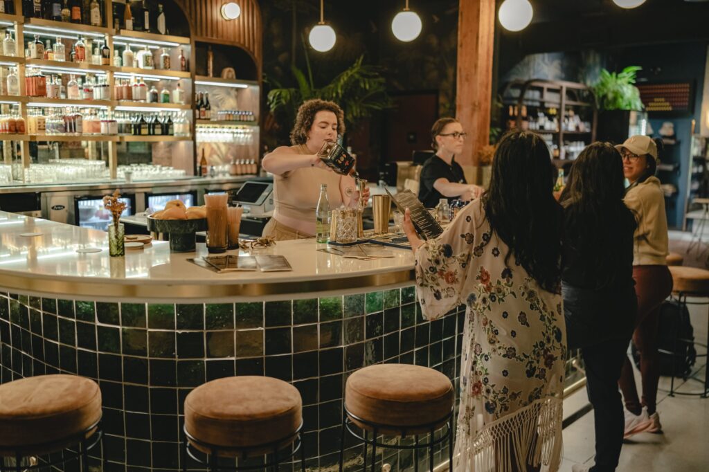Bartenders preparing drinks for guests of an event at a stylish bar in London