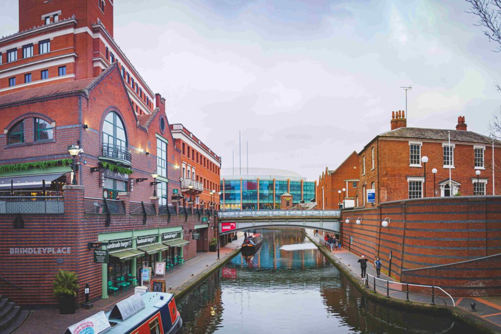 Canal views with red brick buildings to either side in Birmingham (Brindleyplace)
