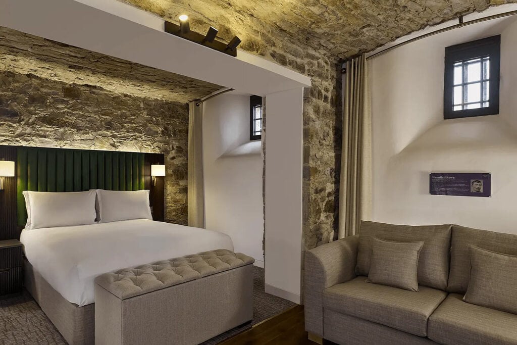 Converted prison cell bedroom with original barred window at The Bodmin Jail Hotel
