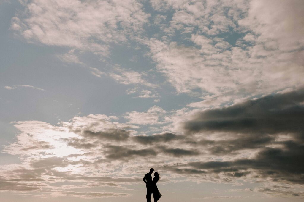 Couple standing together against the sky