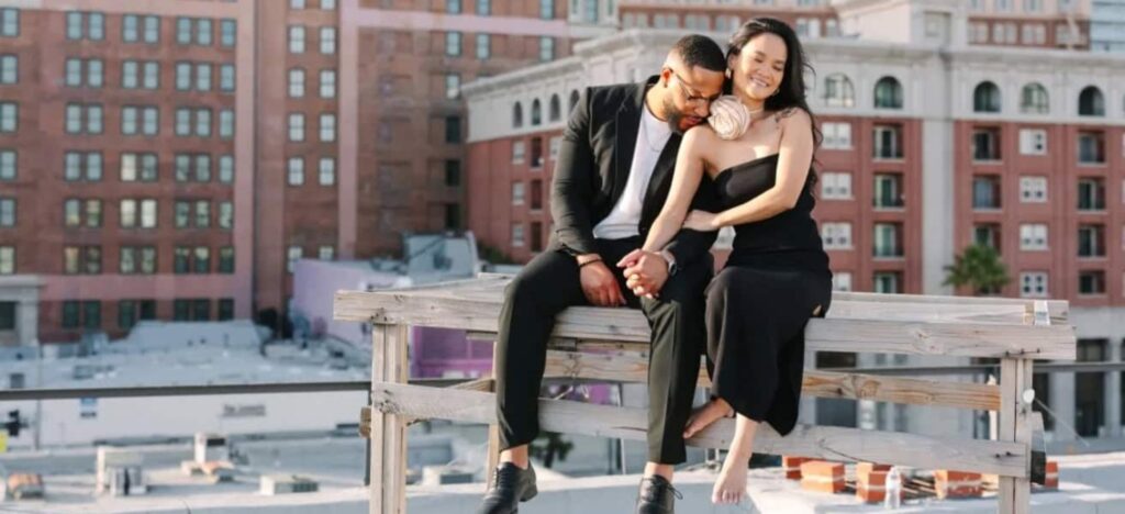 couple holding hands on a rooftop