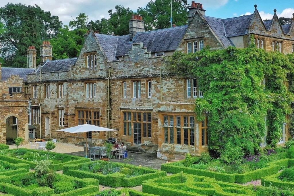 Traditional English country cottage with manicured gardens