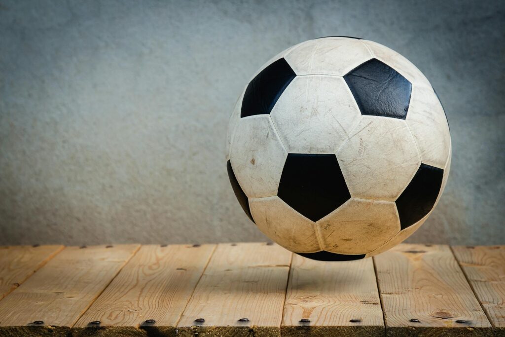 football bouncing on a wooden deck