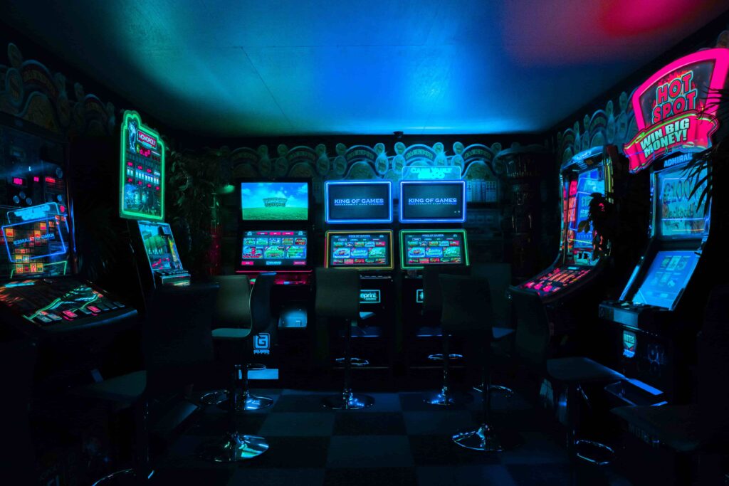 A dark arcade room with glowing machines.