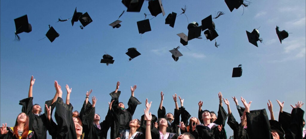 group of graduates tossing their caps in the air