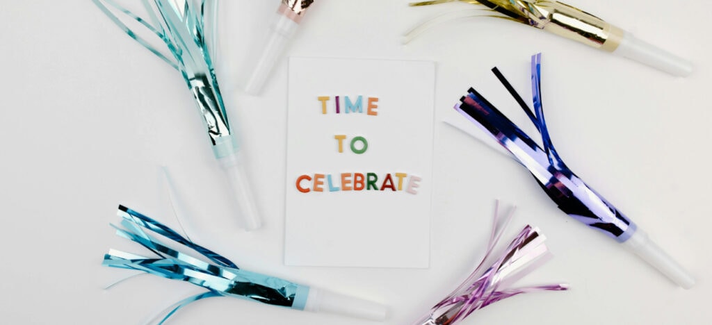 time to celebrate sign with metallic decorations