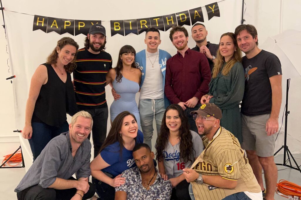 A group of friends celebrating a birthday by taking a group picture in a photo studio