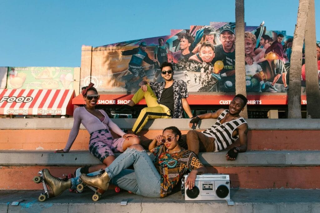 groups in sat on stairs with boombox and rollerskates