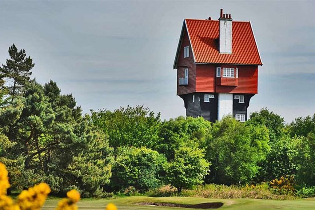 House in the Clouds water tower rising above the treeline at Thorpeness in Suffolk