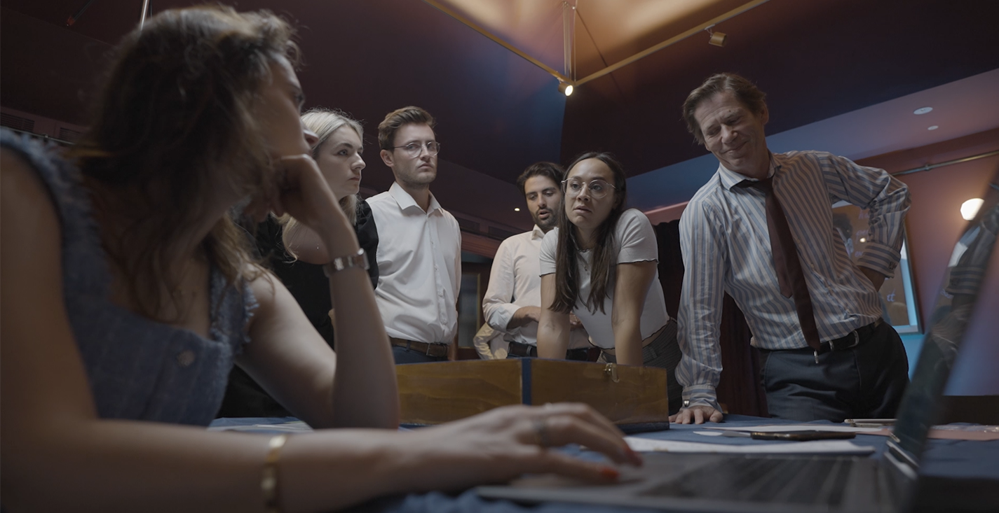 Jury Games London with team of players gathered around a courtroom desk solving an immersive trial mystery scenario