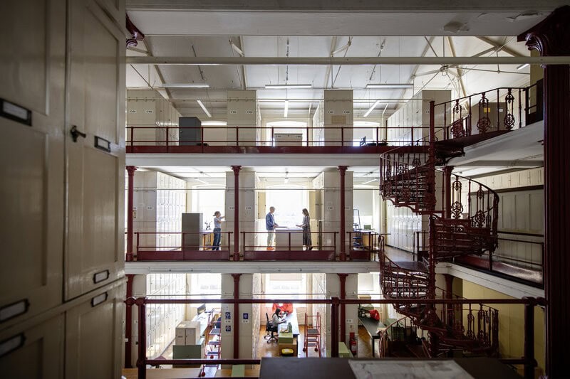 Multi-level herbarium storage galleries and spiral staircase at Royal Botanic Gardens, Kew.