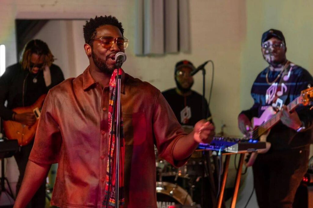 Live band with singer in the foreground playing music in an event venue