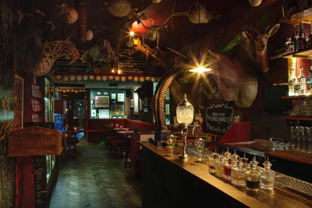 Bar with theatrical decor with velvet, candlelight, and curated eccentricity in Hackney, London