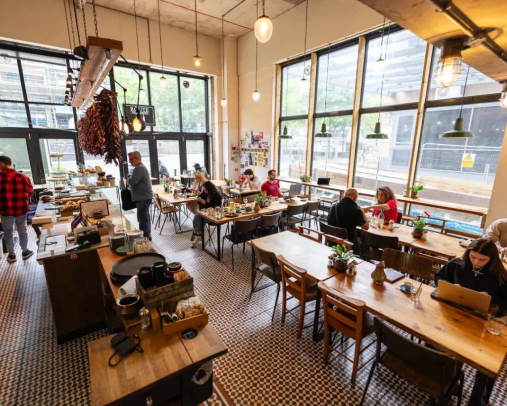 Cozy cafe with large windows and long tables in Dalston, London