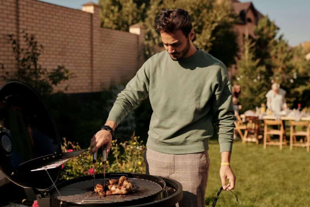 man grilling food on a bbq