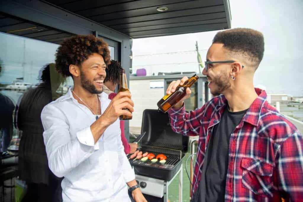 men laughing and drink beer together