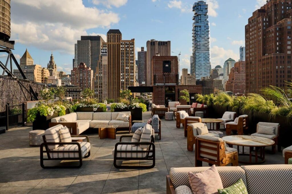 large rooftop terrace with chairs and cityscape backdrop
