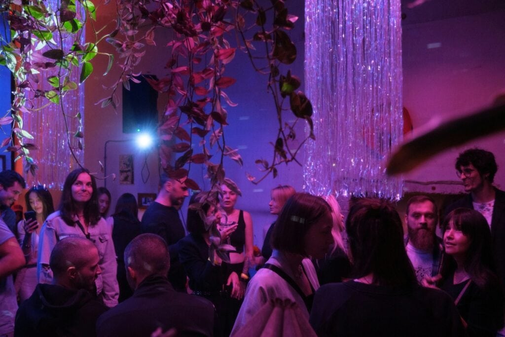 party people in neon lighting and with streamer decorations