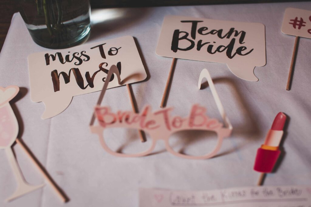 Photo props for a hen do saying "Team Bride" and "Bride to be".