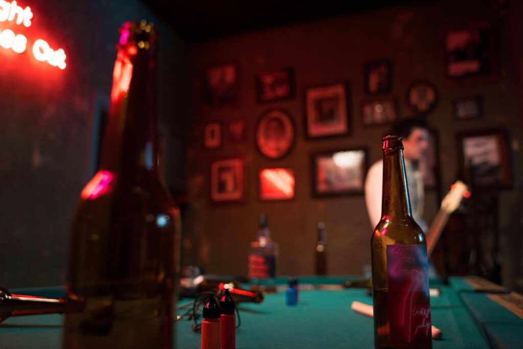 View of a pool table with beer bottles inside a pub