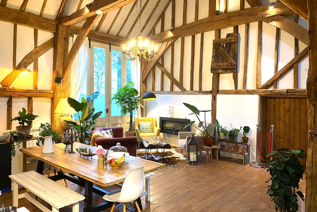 Converted timber barn with a long dining table set up for a private group celebration