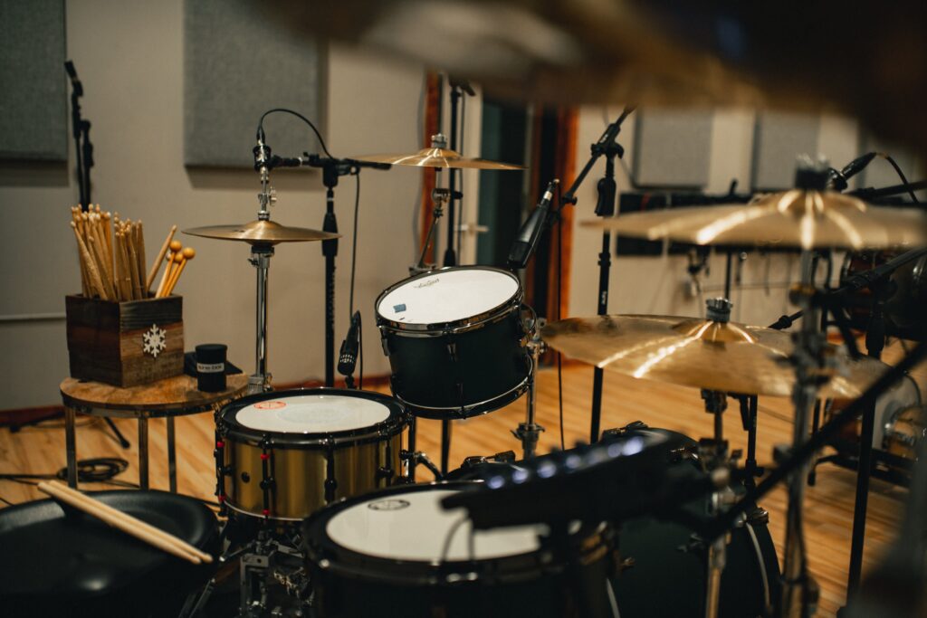 Drums with microphones in a large recording studio