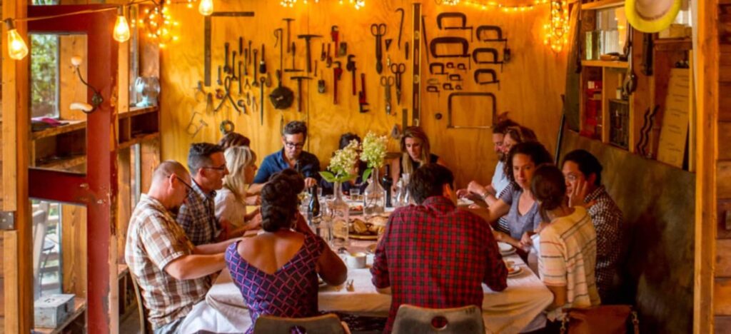 people around a rustic dinner table