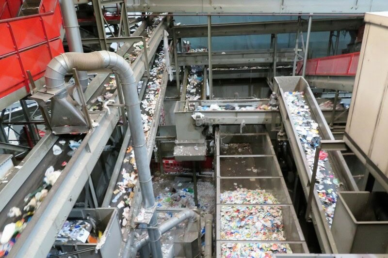 Conveyor belts sorting mixed recycling inside Southwark Integrated Waste Management Facility.