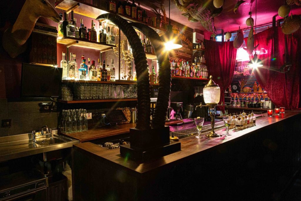 Candlelit absinthe bar above a museum of curiosities in Hackney