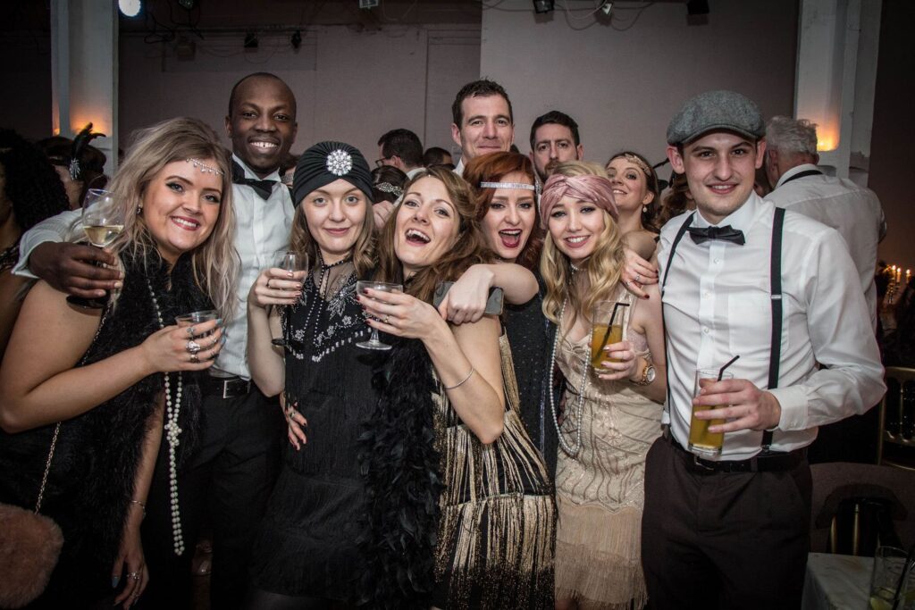 The Candlelight Club London with guests in 1920s flapper dresses and three-piece suits at a Prohibition-era speakeasy night