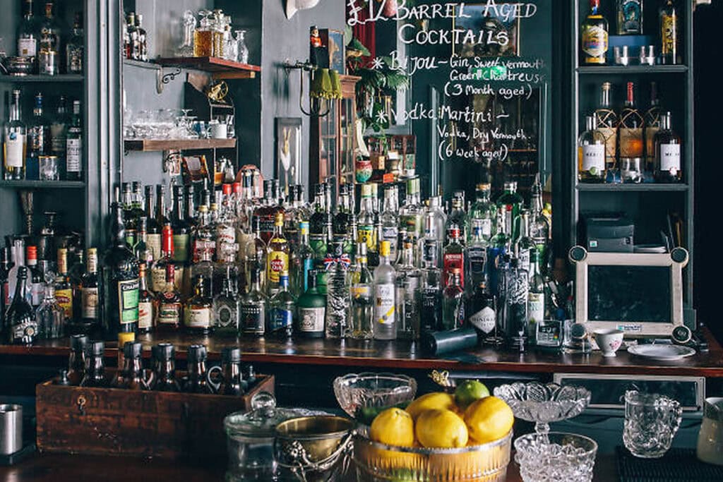 Back bar lined with spirits and vintage glassware at The Milk Thistle in Bristol