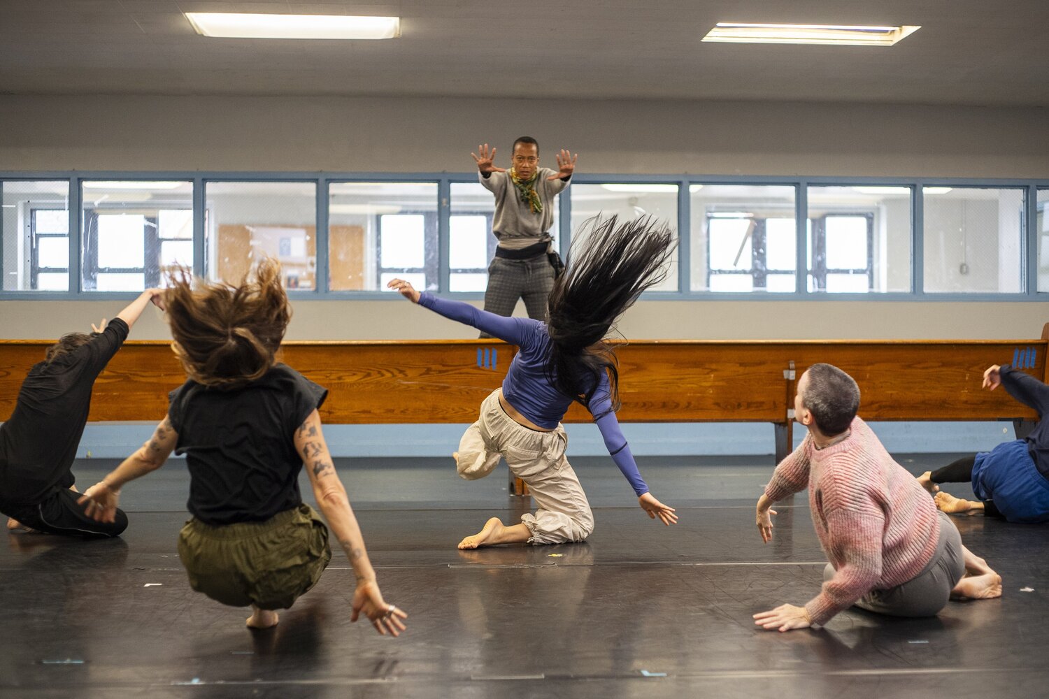 Dancers mid-leap during rehearsal for The Surge at Aviva Studios Manchester