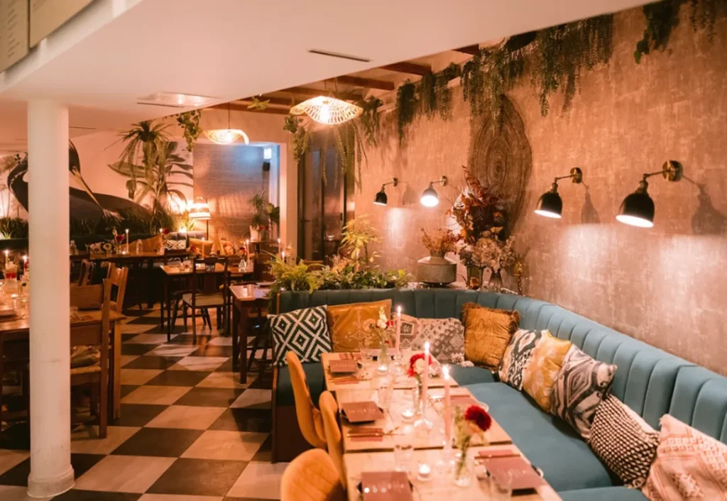 Café and cocktail bar with bohemian design featuring leafy, tropical decor in Barnes, London