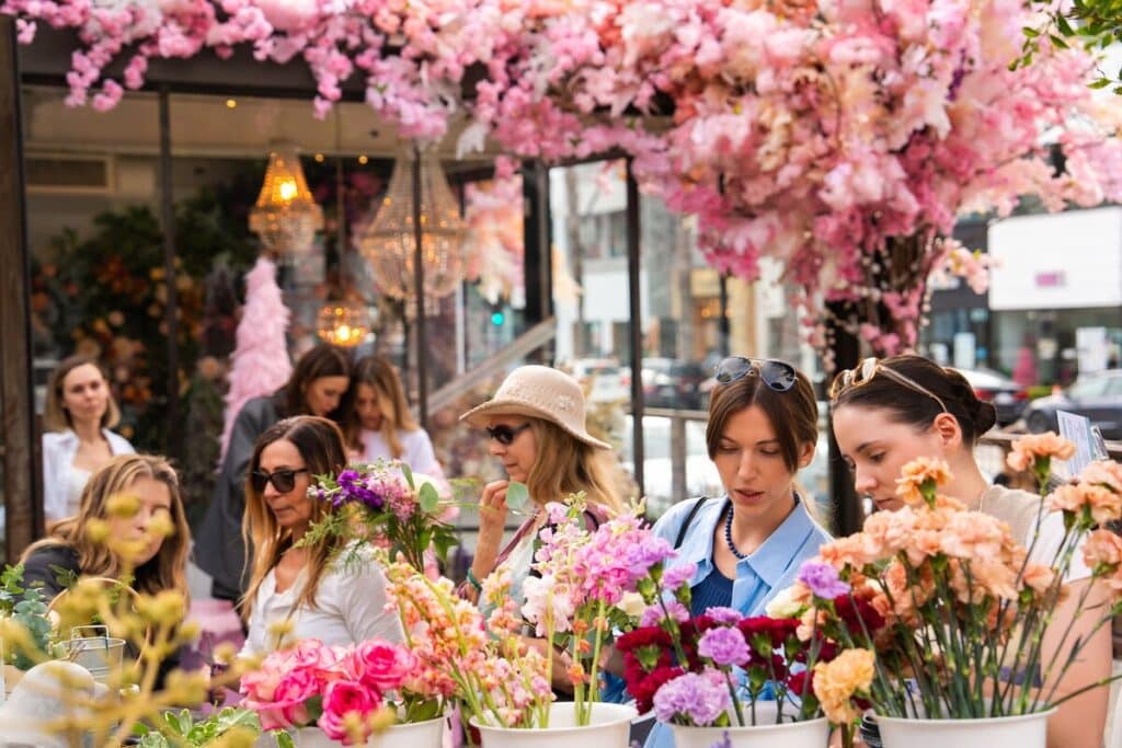 people perusing bright flower arrangements